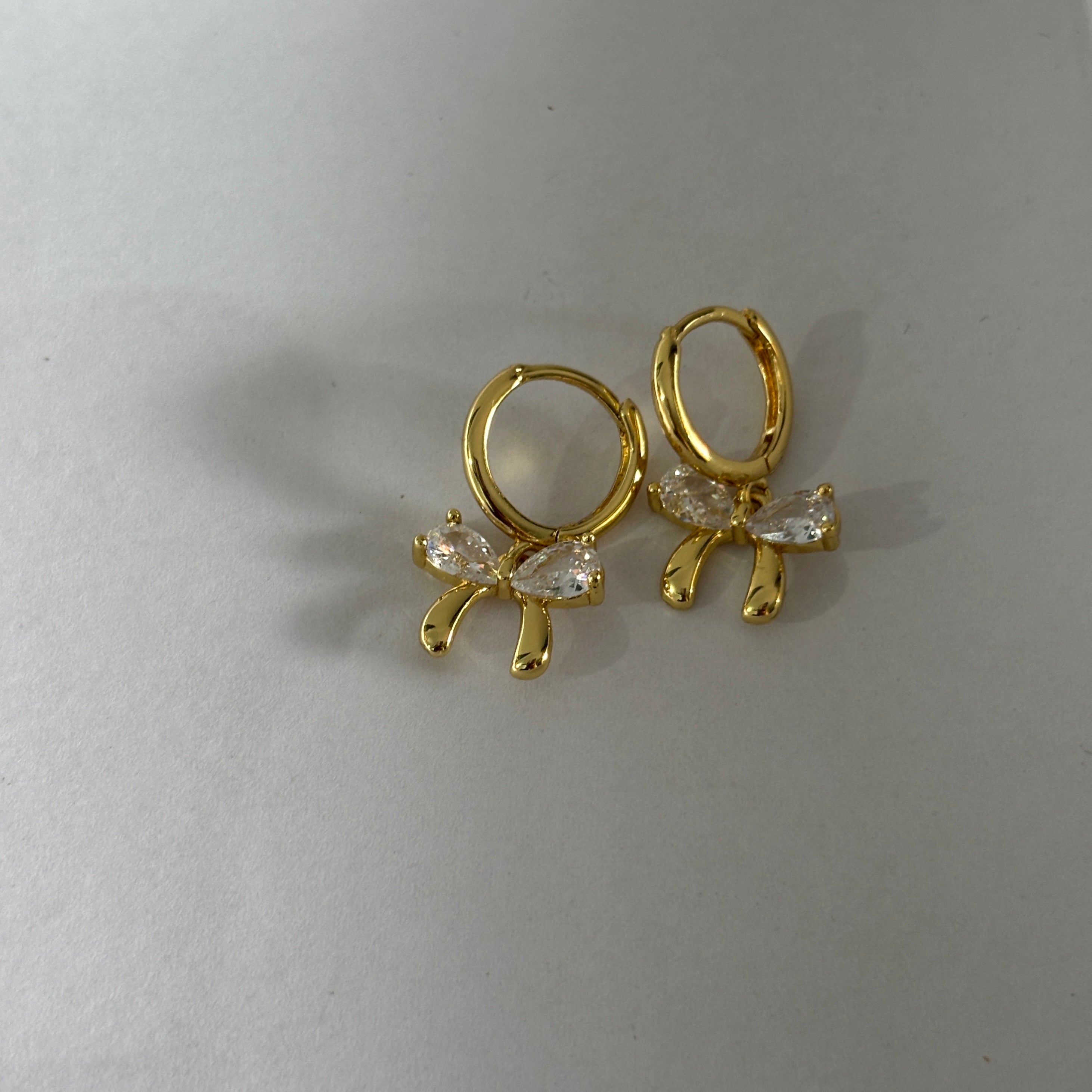 Bow huggie earrings